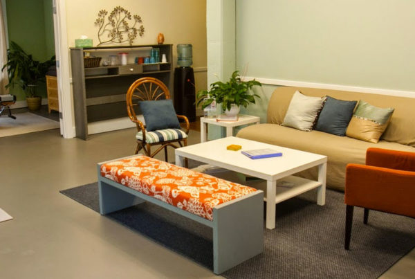 A living room with two couches, a coffee table and a bench.