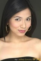 Here's a short alt tag for the image: `Headshot of a young woman with dark hair.`