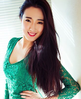 Smiling woman with long black hair.