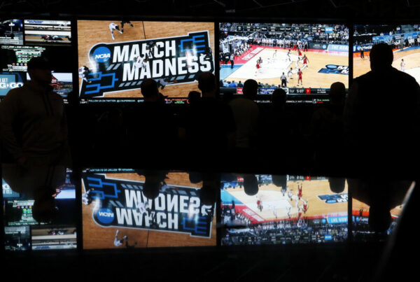 March Madness basketball games on screen.